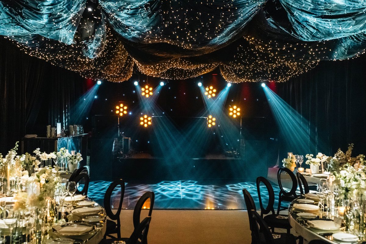 Elegant gala dinner venue with ambient lighting and floral table settings